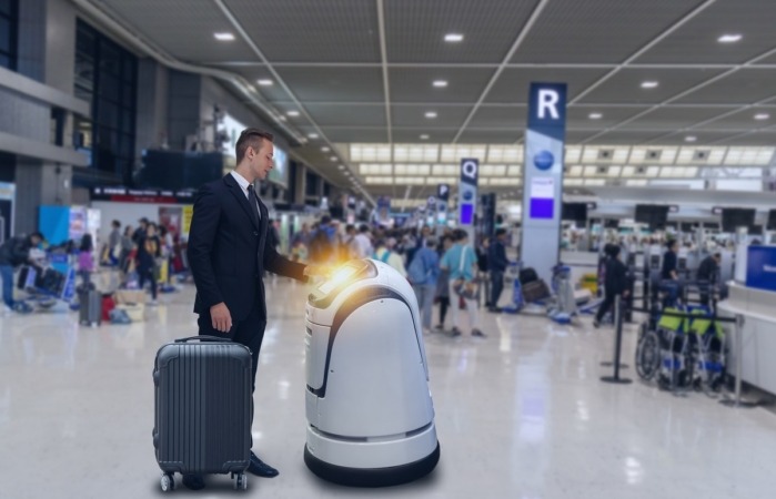 Smart robotic technology concept, The passenger follow a service robot to a counter check in in airport, the robot can help and give some information to passenger quickly