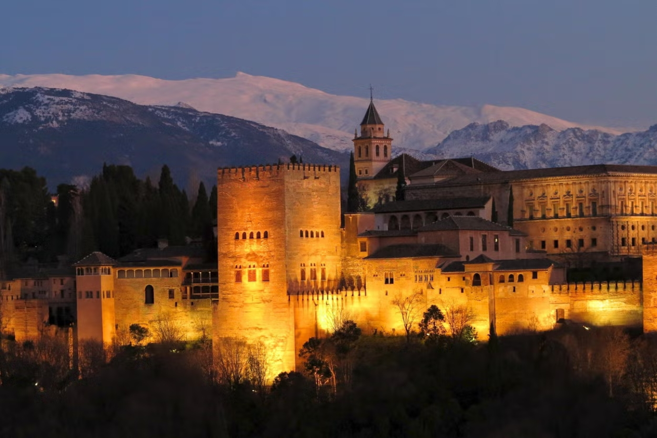 La imponente Sierra Nevada se advierte sobre la Alhambra de Granada incluso al albor de la noche.